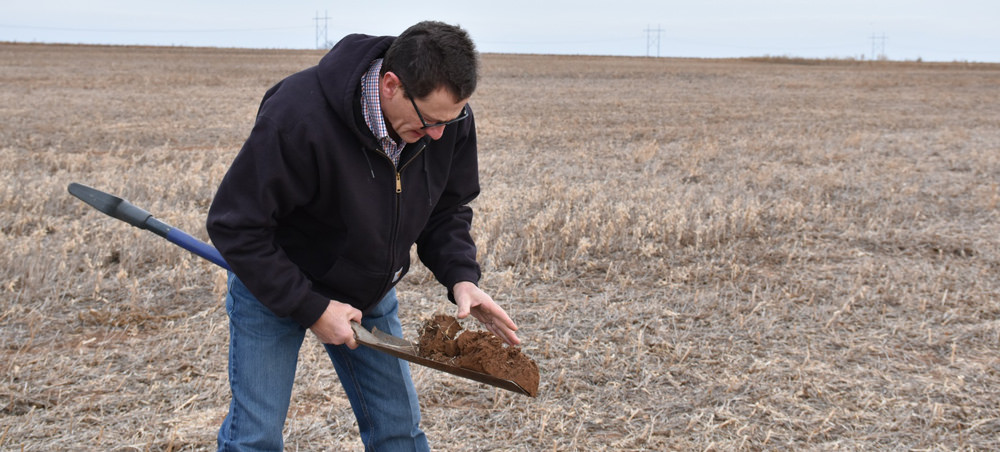 Farmer in field with shovel