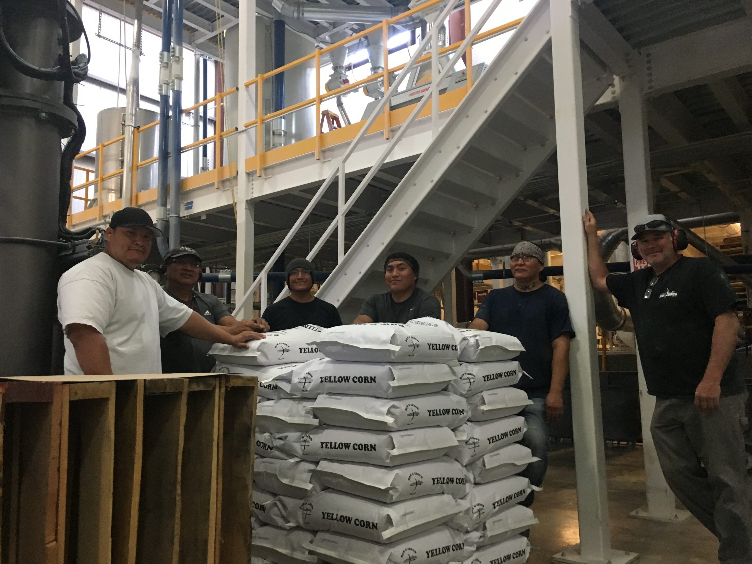 Bow & Arrow employees with bags of non-GMO corn