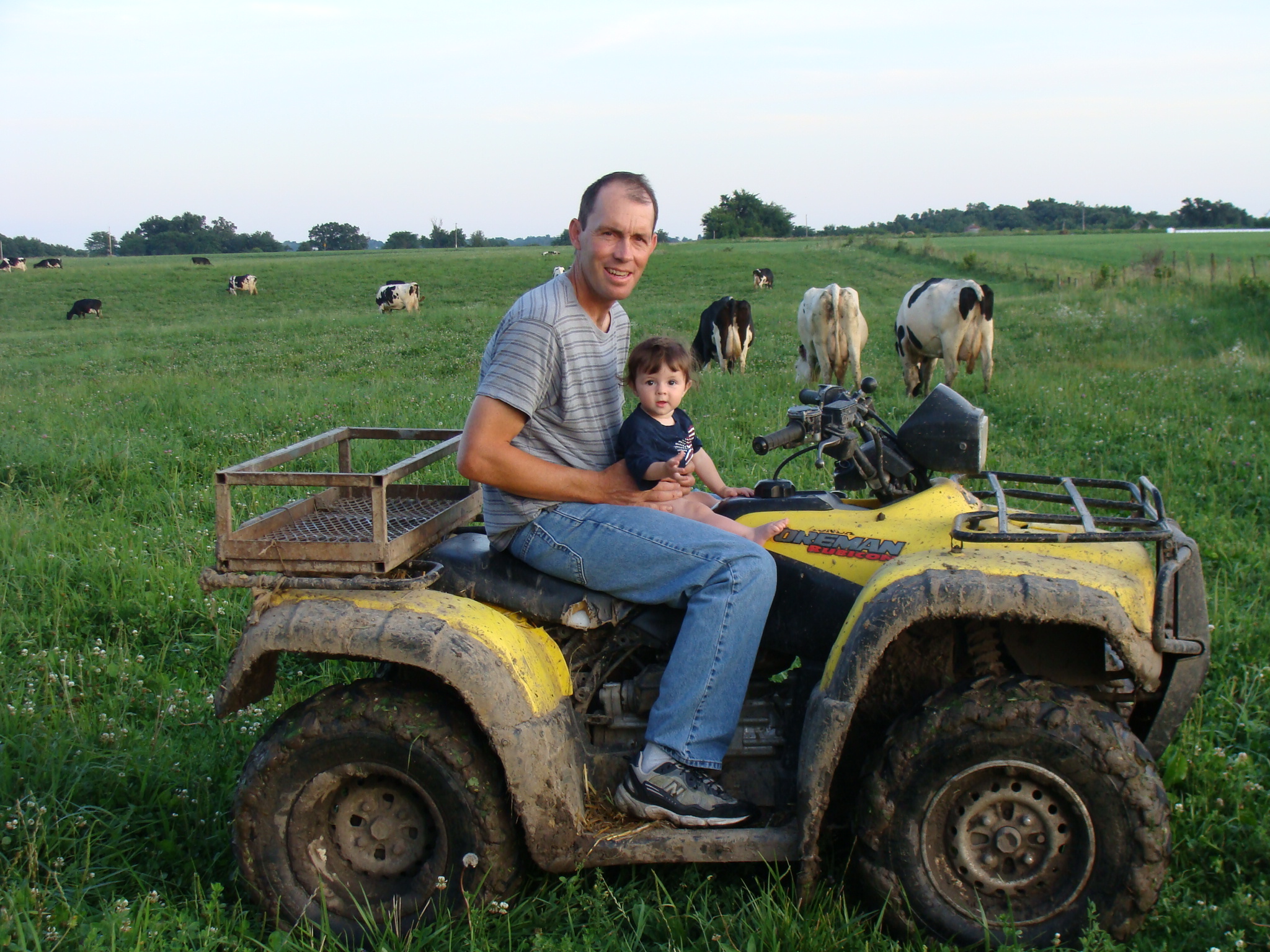 Jason Wells and child on tractor