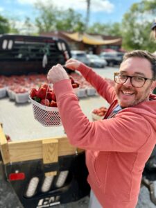 Justin assisting with a strawberry delivery
